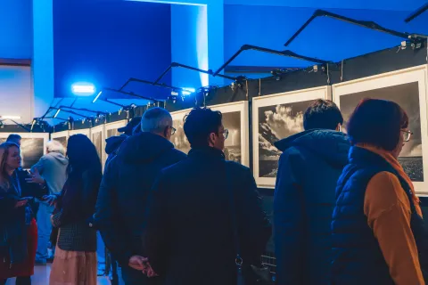 Visiteurs dans l’exposition de photographies en noir et blanc.