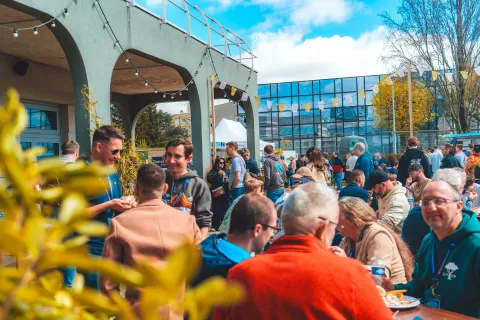 Déjeuner en terrasse : la foule attablée sous les arches, au soleil.